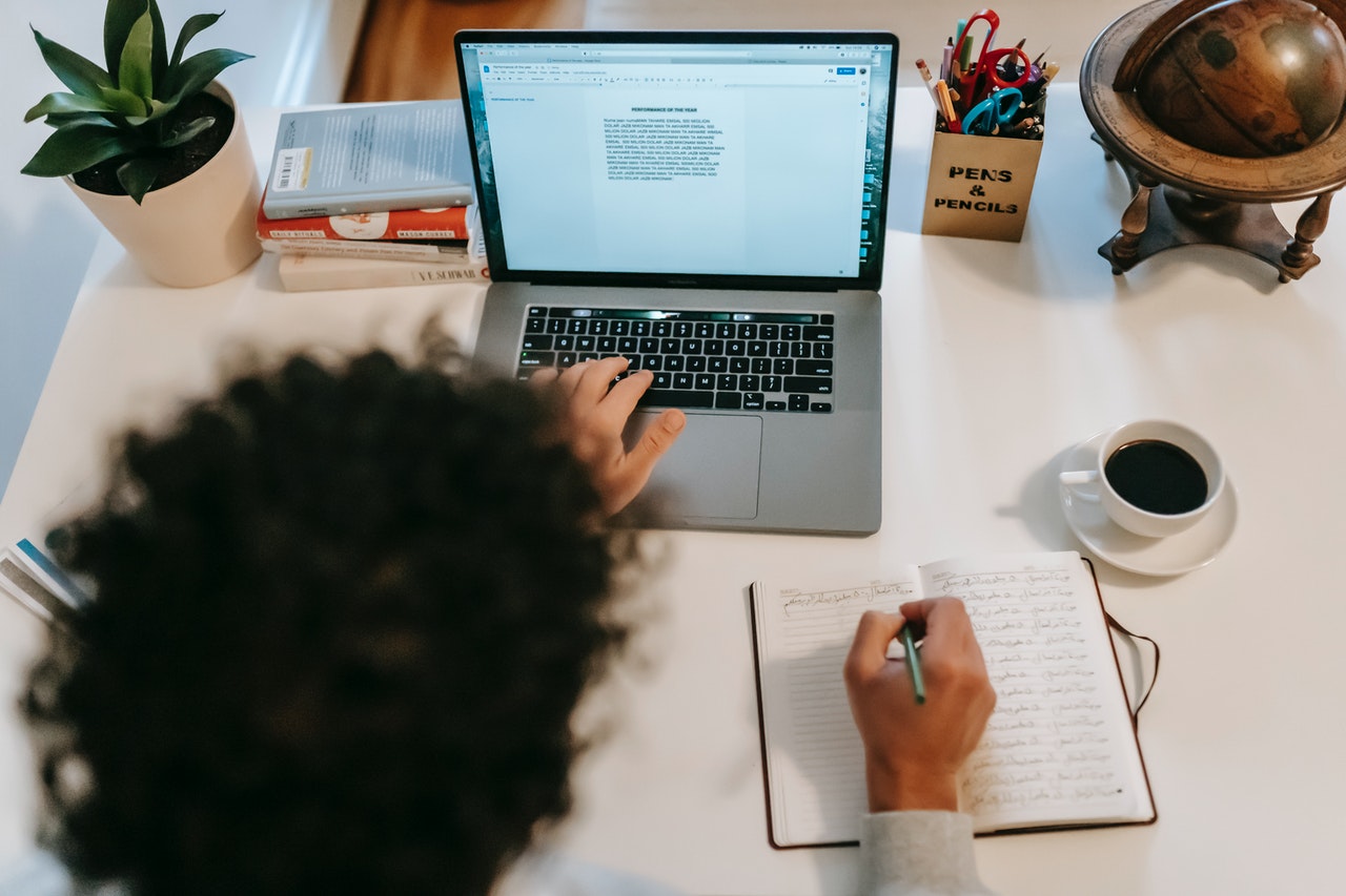 Person writing on laptop