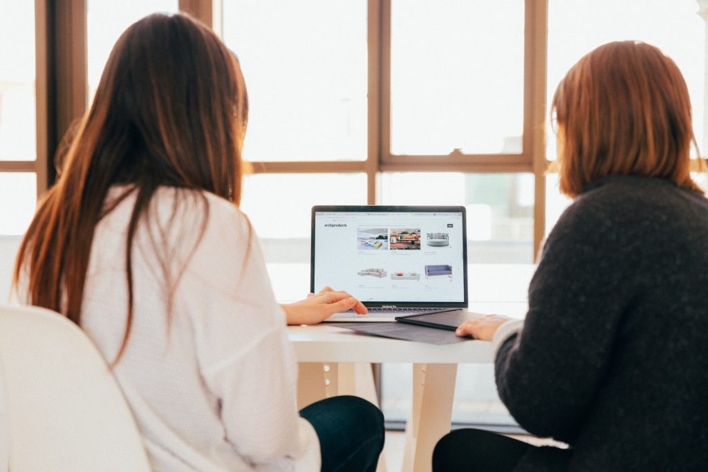 Women sitting in front of a laptop