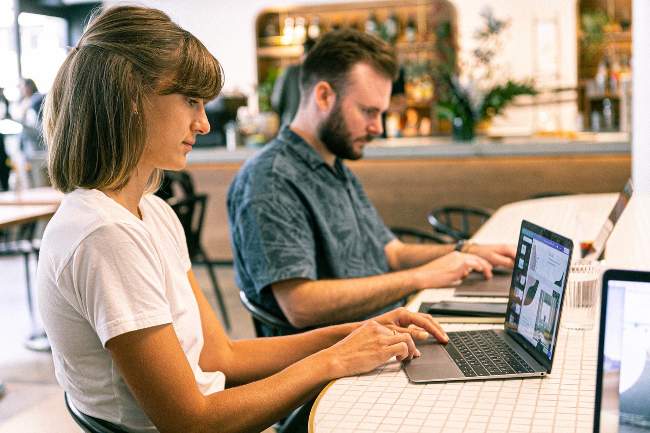 Woman and man on computers